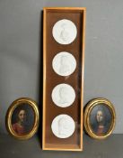 A cased selection of plaster miniatures featuring historical figures and two oval icons of Jesus and