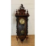 A mahogany cased eight day Vienna wall clock with finial and horse crown and brass dial and pendulum