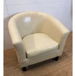 A faux leather tub chair