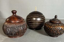 A selection of four wooden carved lidded pots
