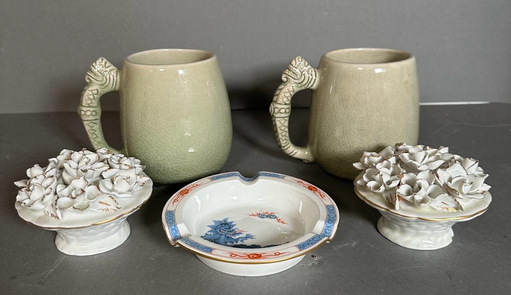 A selection of ceramics to include two Thai crackle glazed mugs, a pair of floral displays and a