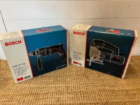 Two boxed Bosch power tools, a jigsaw and a impact drill