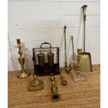 A selection of brass items to include candle sticks, fireside companion set and a tantalus AF