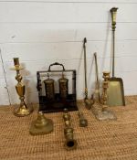 A selection of brass items to include candle sticks, fireside companion set and a tantalus AF