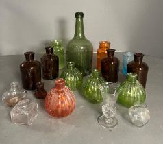 A selection of coloured glass bottles various ages
