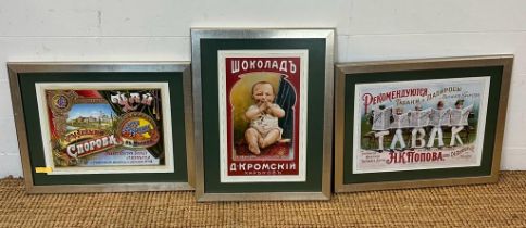 A selection of three framed Russian advertising posters