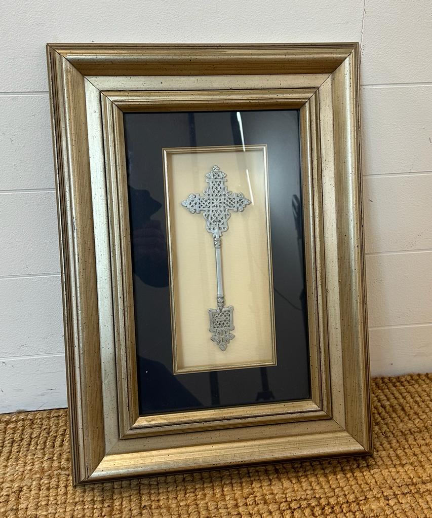 A framed white metal Ethiopian Coptic cross
