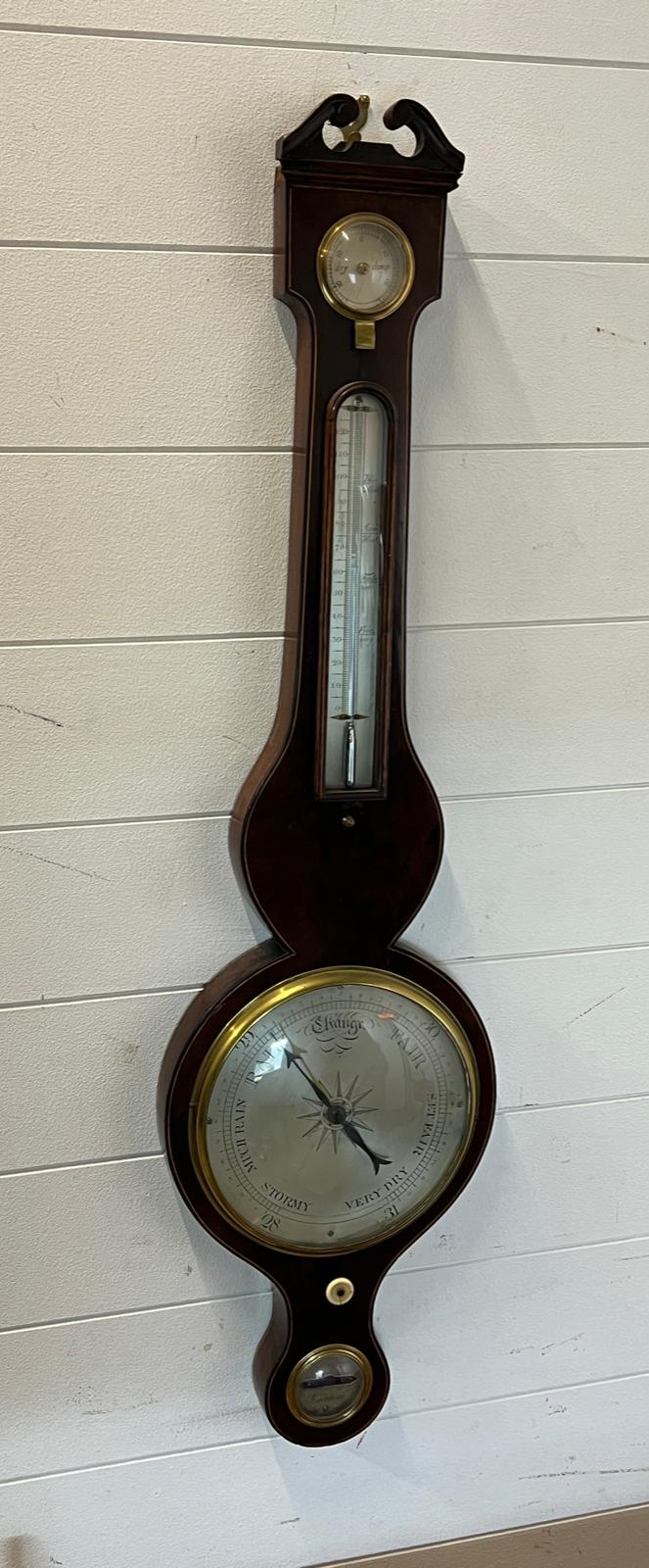 A banjo barometer with scrolling top