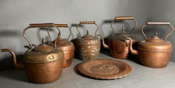 Five copper kettles and a hammered copper plate