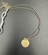 A 9ct gold St Christopher (Approximate weight 2g) on a separate silver chain.