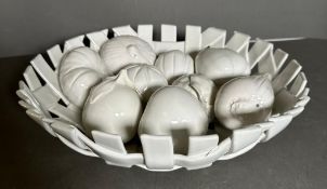 A white ceramic lattice work bowl with a selection of ceramic fruit AF