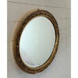 An oval gilt framed hall mirror