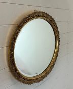 An oval gilt framed hall mirror