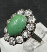An outstanding jade and diamond ring a central jade stone surrounded by eleven diamonds (