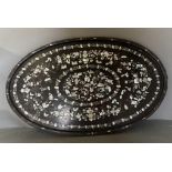 An oval oriental ebony tray with a floral mother of pearl inlay on stand 84cm x 52cm