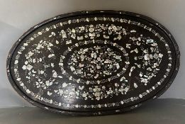 An oval oriental ebony tray with a floral mother of pearl inlay on stand 84cm x 52cm