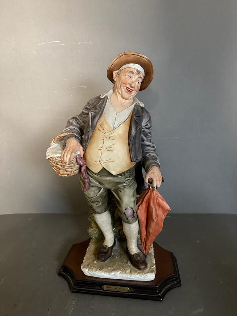 A selection of four Capodimonte figures to include Gentleman on benches, a man with a basket and a - Image 6 of 6