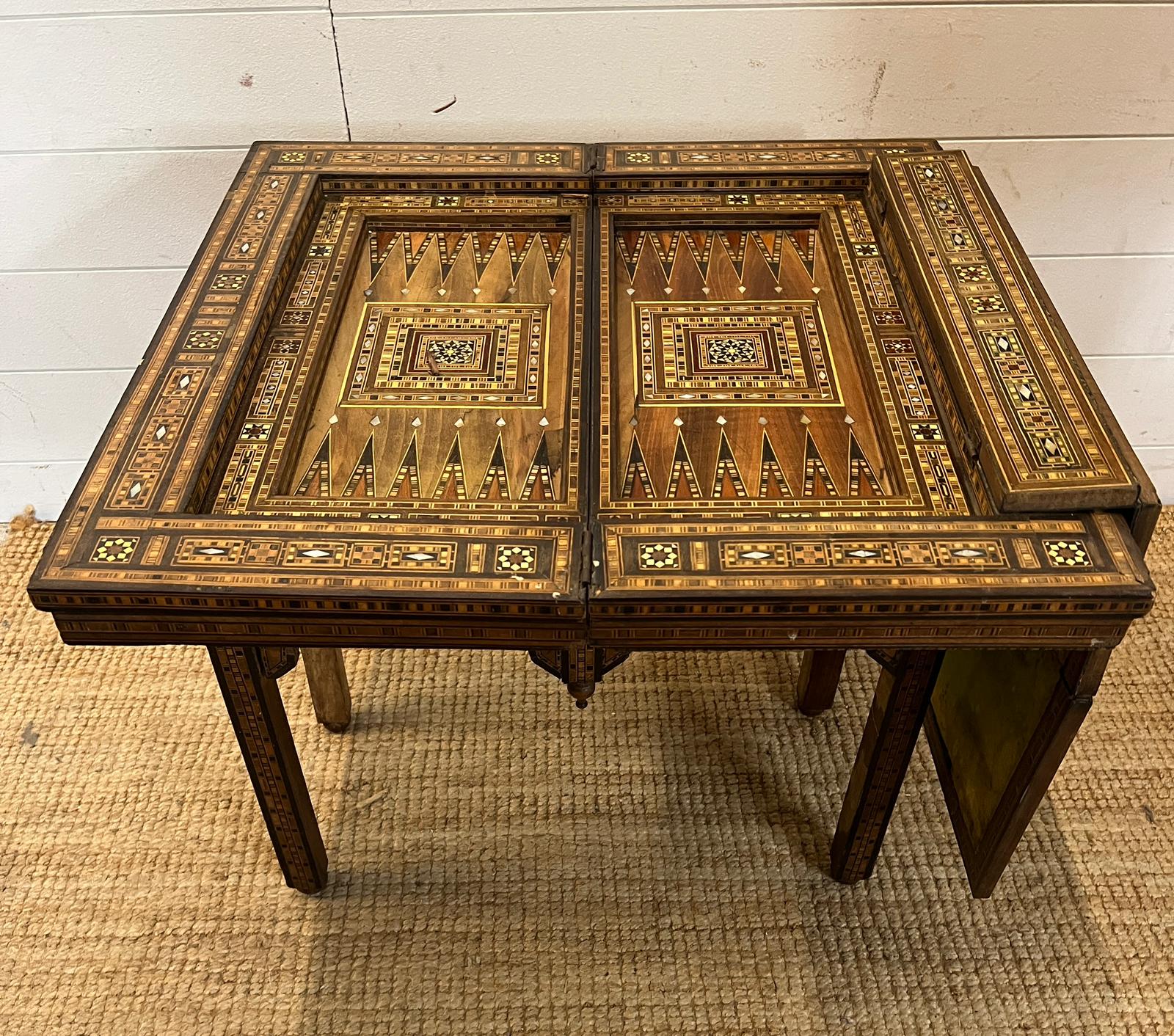 A marquetry inlaid games table with playing surface, back gammon, chess board etc , Damasais or - Image 7 of 9