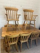 A pine farmhouse table with eight chairs (H77cm W168cm D83cm)