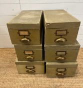 Six vintage green storage boxes