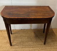 A mahogany folding card table with string inlay and tapering legs (H76cm W94cm D46cm)