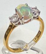 An opal and diamond ring, approximate size K, opal approximately 8mm long.