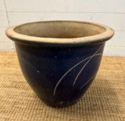 A blue glazed terracotta garden pot