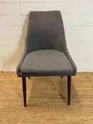 A contemporary grey upholstered office chair on splayed legs