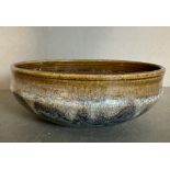 A Studio pottery bowl glazed in browns, blues and greys