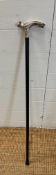 A black painted walking cane with an Art Deco style white metal handle