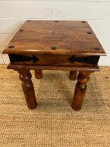 A hardwood side table with metal work studs to top (H50cm Sq45cm)