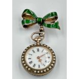 A green enamel and silver pocket watch with Fleur De Lis decoration along with seed peals around the
