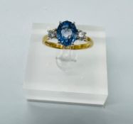 An 18ct gold topaz ring with diamond shoulder, makers mark CWJ and size P