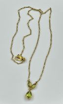 A 9ct gold fine necklace with three peridot stones approx 3.8g