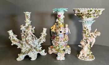 Two figural Dresden ceramic centre pieces and a three arm candle stick holder