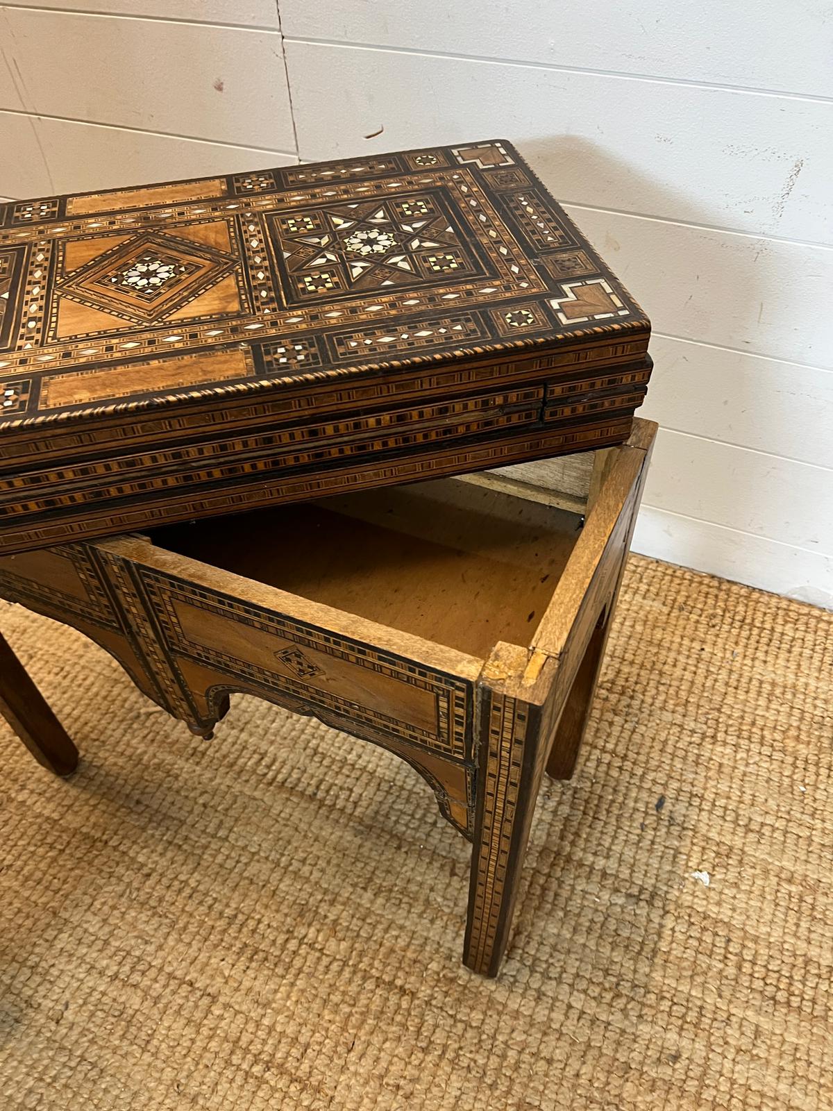 A marquetry inlaid games table with playing surface, back gammon, chess board etc , Damasais or - Image 3 of 9