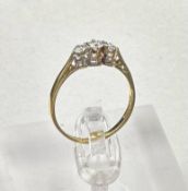 An 18ct three stone diamond ring, approximate size M1/2