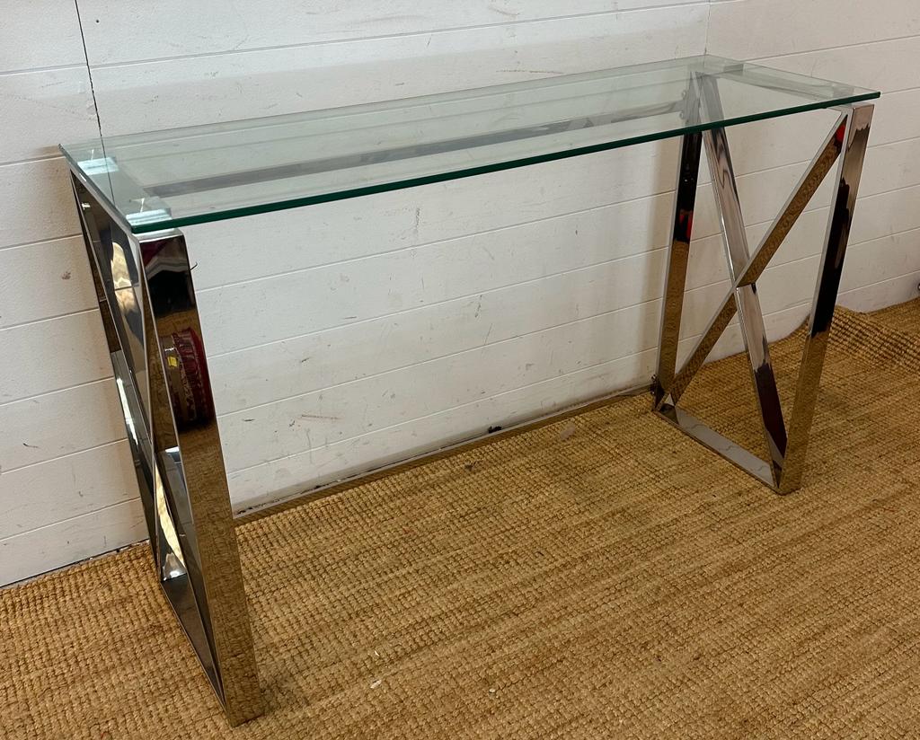 A contemporary chrome based console table with glass top Height 78 40x120