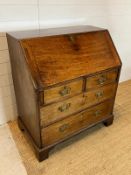 A mahogany bureau opening to writing slope and bracket feet (H104cm W92cm D56cm)