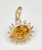 A citrine and 9ct gold brooch with saftey chain, approximate total weight 6g.