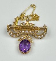 A 9ct gold brooch with amethyst and seed pearl decoration, with safety chain and approximate