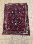 A red ground rug nomadic Shiraz rug in creams, blues and oranges 110cm x 90cm
