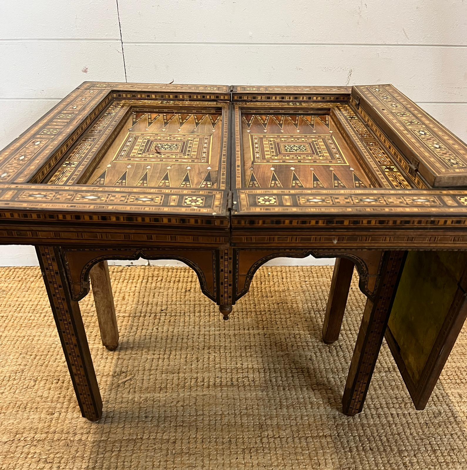 A marquetry inlaid games table with playing surface, back gammon, chess board etc , Damasais or - Image 8 of 9