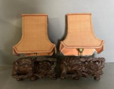 A pair of Chinese hardwood wall sconces in the form of elephants