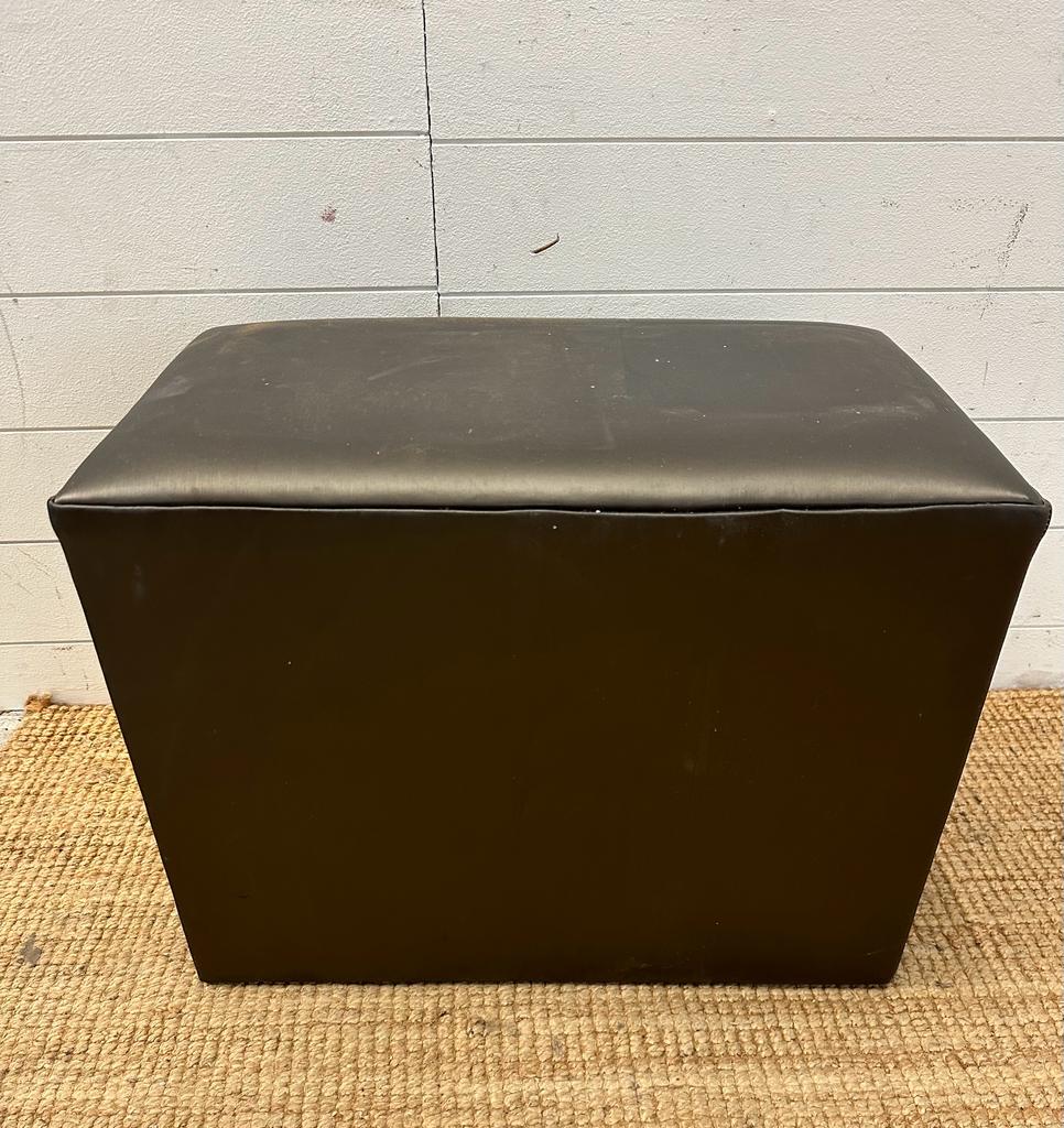 A brown faux leather foot stool
