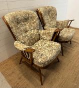 A pair of Ercol Evergreen Easy chairs with button back floral upholstery