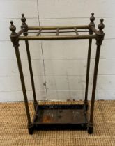 A Victorian brass umbrella or stick stand with cast iron drip tray