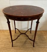 An Edwardian mahogany and painted centre table. Height 75 diameter 69