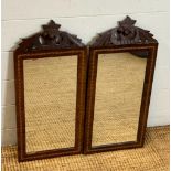 A pair of mahogany mirrors with marquetry inlay and acorn carved tops 60cm x 28cm
