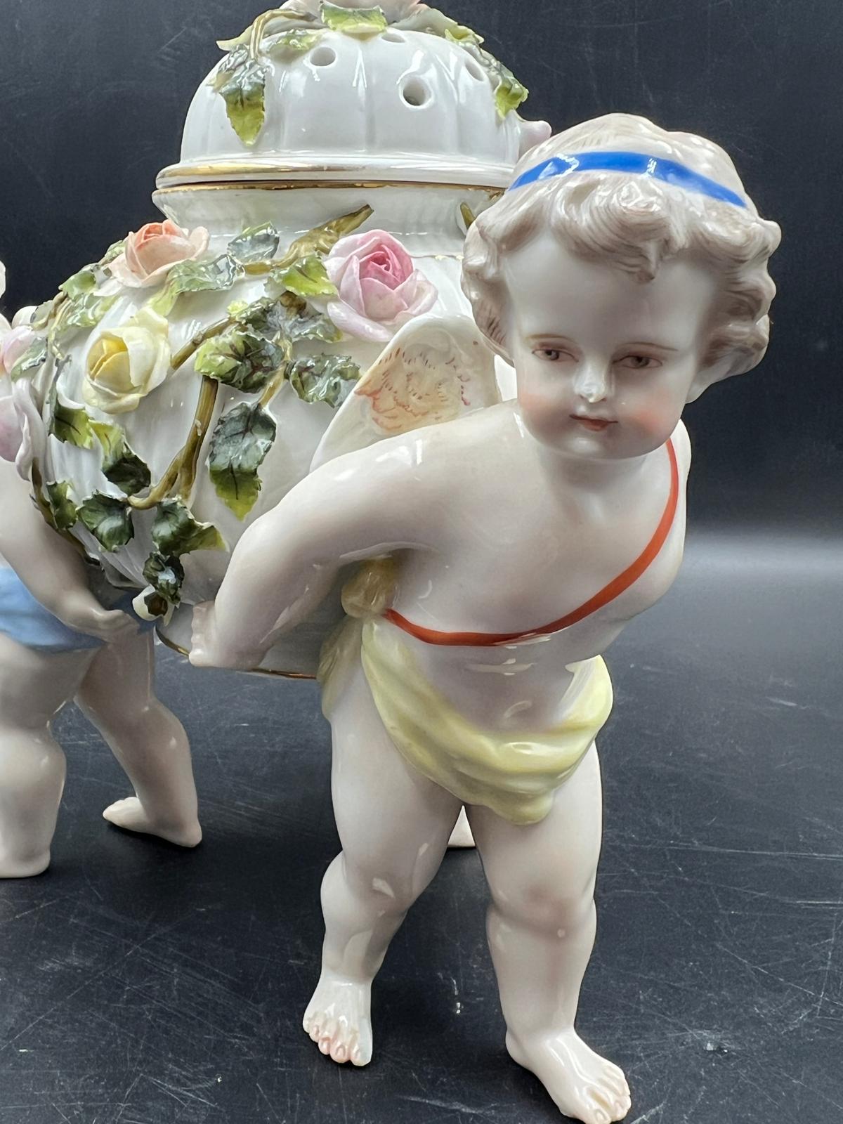 A Sitzendorf porcelain center piece with three cherubs supporting a lidded bowl decorated with - Image 2 of 5